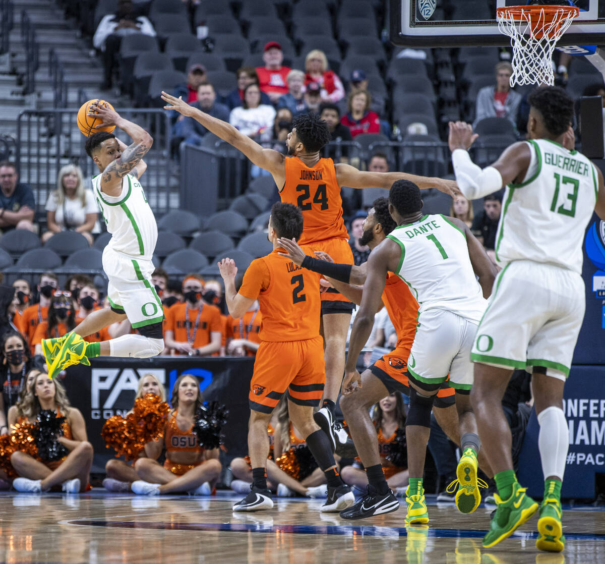 Oregon Ducks guard Jacob Young (42) looks to pass from the air defended by Oregon State Beavers ...