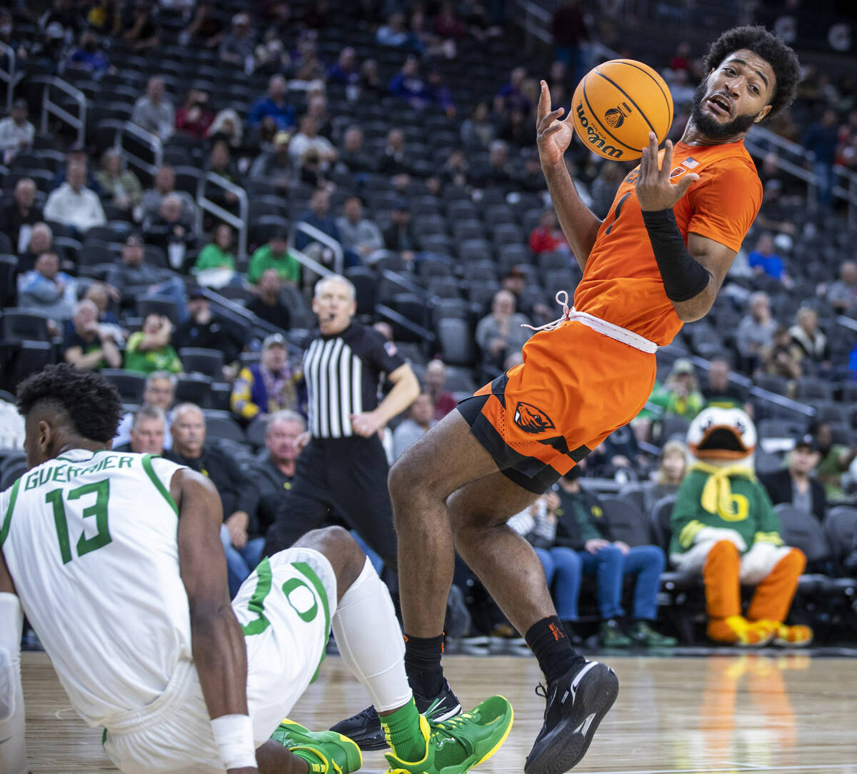 Oregon State Beavers forward Maurice Calloo (1) loses the ball after charging into Oregon Ducks ...