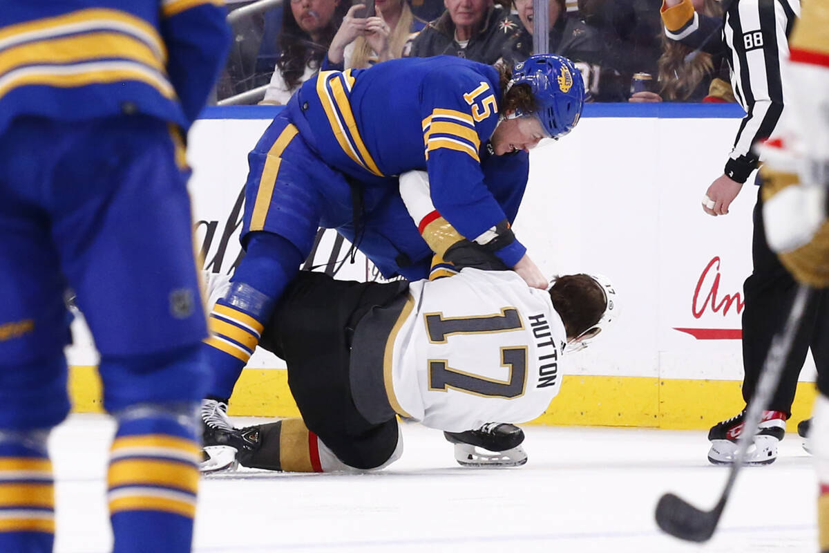 Buffalo Sabres center John Hayden (15) and Vegas Golden Knights defenseman Ben Hutton (17) figh ...