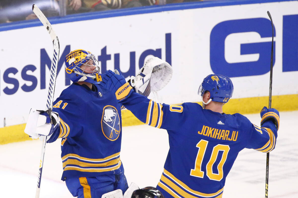 Buffalo Sabres goaltender Craig Anderson (41) and defenseman Henri Jokiharju (10) celebrate the ...