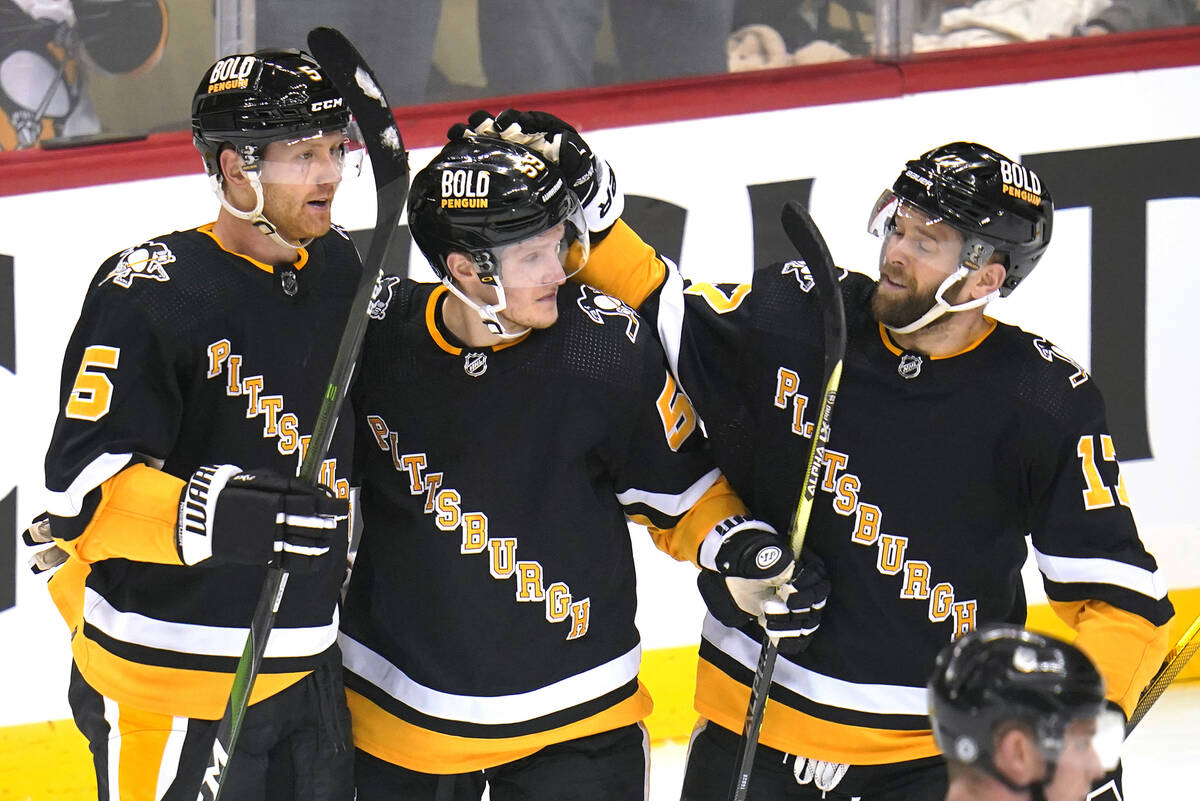 Pittsburgh Penguins' Mike Matheson (5) celebrates his goal with Jake Guentzel (59) and Bryan Ru ...