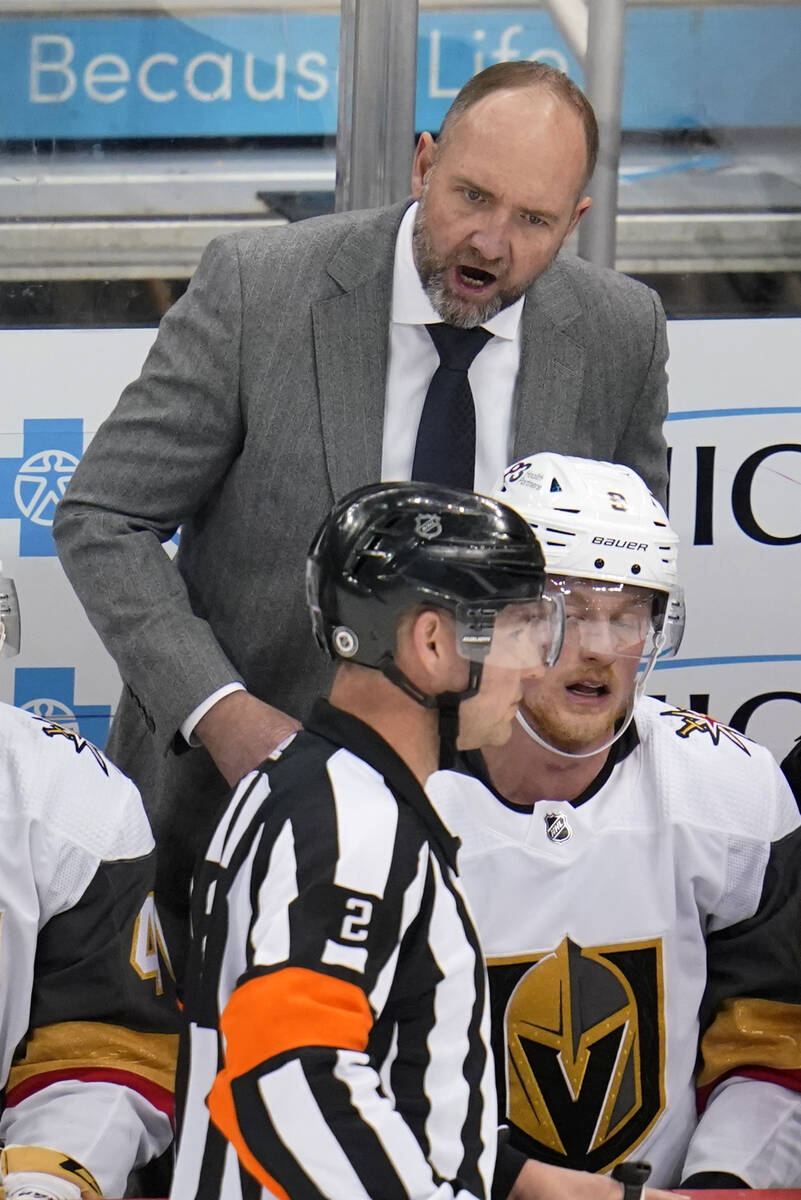 Vegas Golden Knights coach Peter DeBoer has a word with referee Jon McIsaac (2) during the firs ...