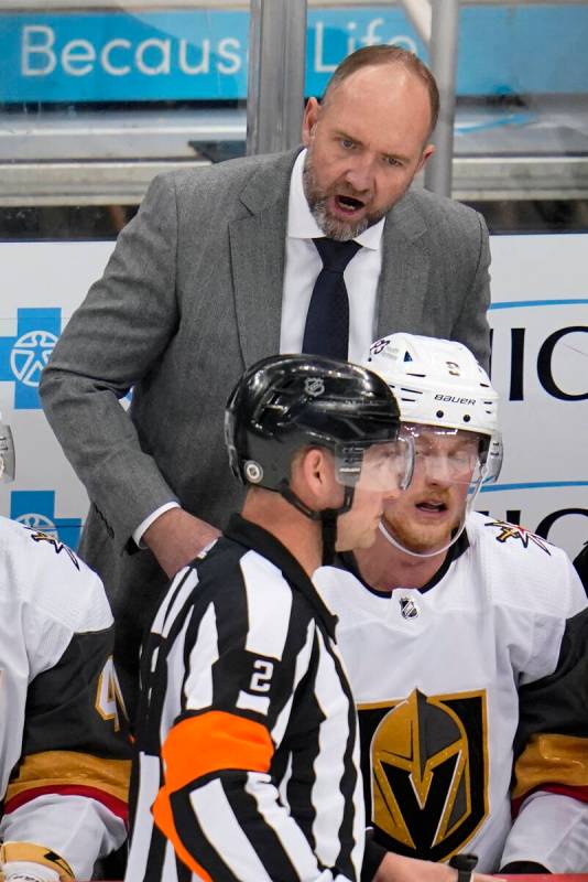 Vegas Golden Knights coach Peter DeBoer has a word with referee Jon McIsaac (2) during the firs ...