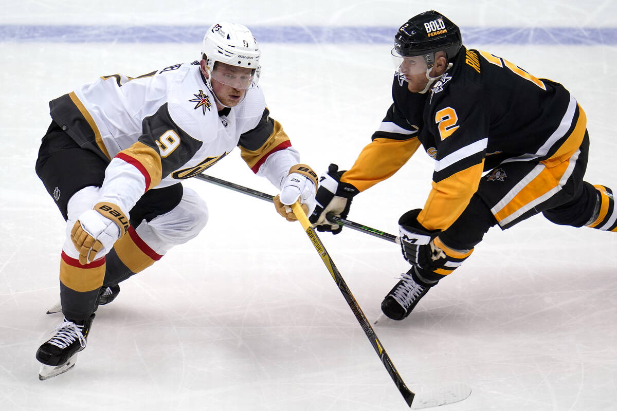 Vegas Golden Knights' Jack Eichel (9) gets around Pittsburgh Penguins' Chad Ruhwedel during the ...
