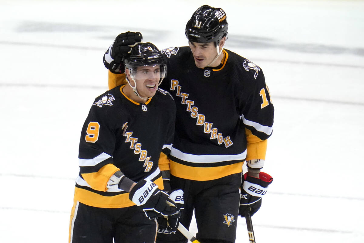 Pittsburgh Penguins' Evan Rodrigues (9) celebrates with Brian Boyle after scoring an empty-net ...
