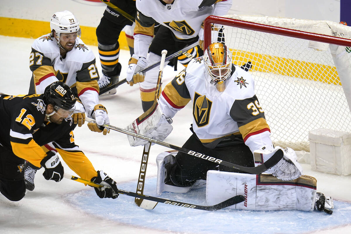 Vegas Golden Knights goaltender Laurent Brossoit (39) makes the save on a shot by Pittsburgh Pe ...
