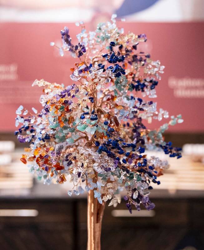 A tree made out of citrine, lapis lazuli, amethyst, aquamarine, jade, and quartz stones, known ...