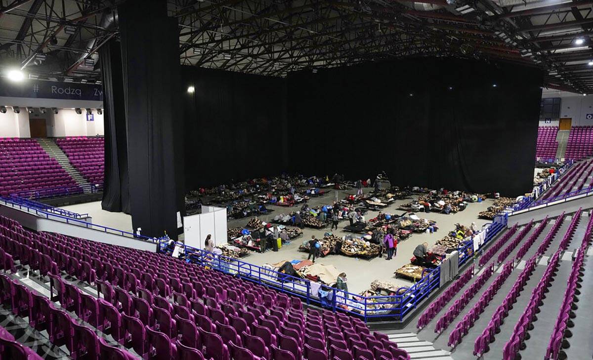 Refugees from the war in Ukraine seek shelter in a sports center in Warsaw, Poland, on Friday M ...