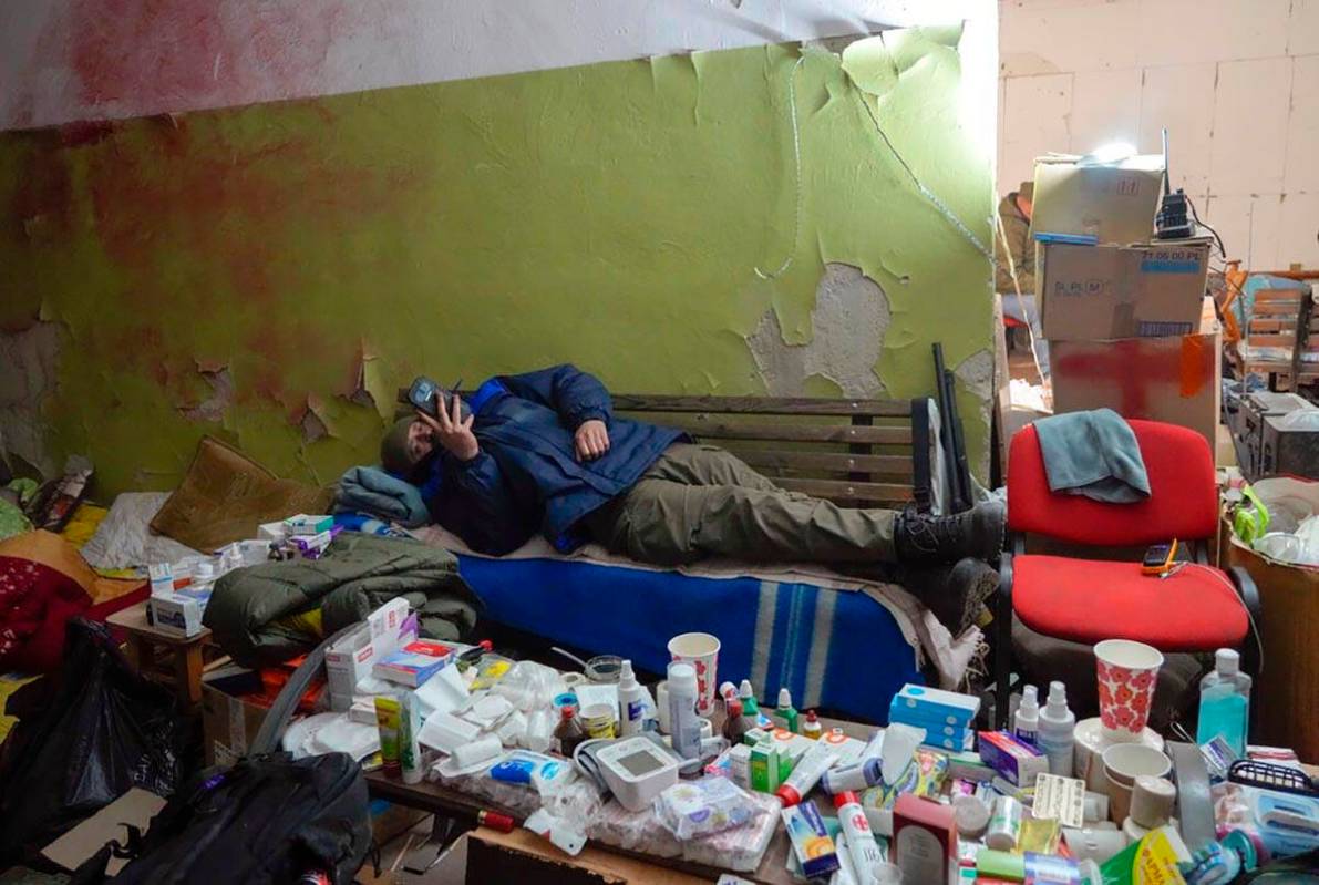 A local citizen rests in a basement for shelter in the center of the town of Irpin, some 25 km ...