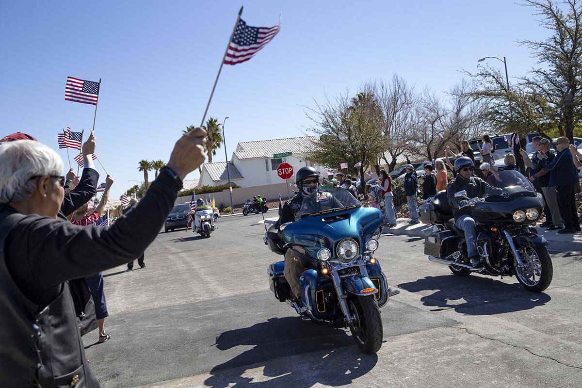 A brigade of motorcycles leads the escort for Army Sergeant Adam Poppenhouse to receive his don ...