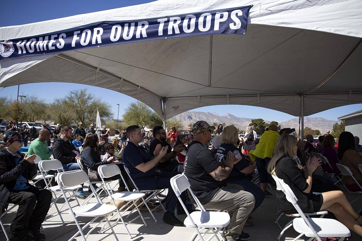Audience members clap for speakers during a Homes For Our Troops event on Saturday, March 12, 2 ...