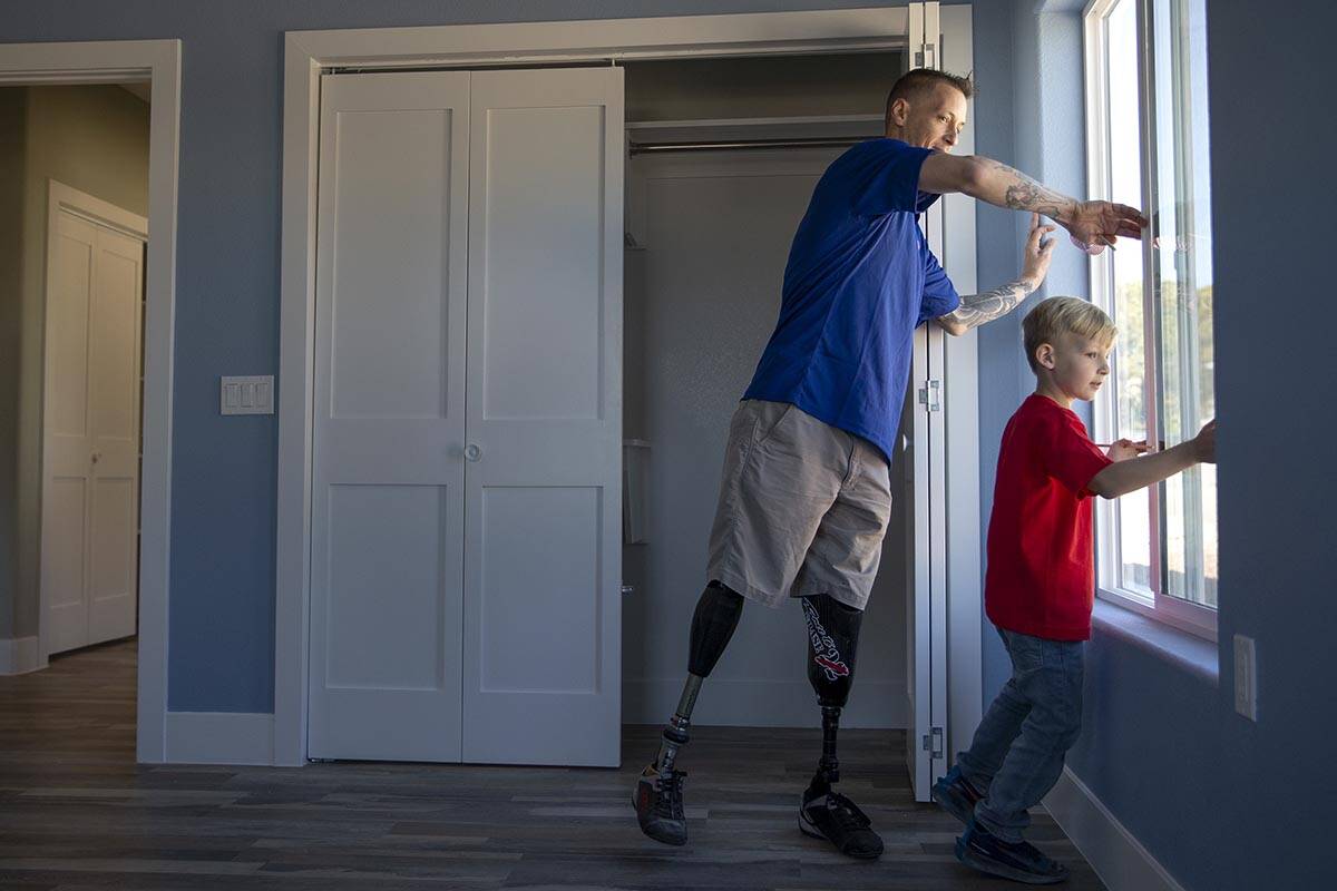 Army Sergeant Adam Poppenhouse, who was injured in Iraq in 2006, and his son A.J. Poppenhouse, ...