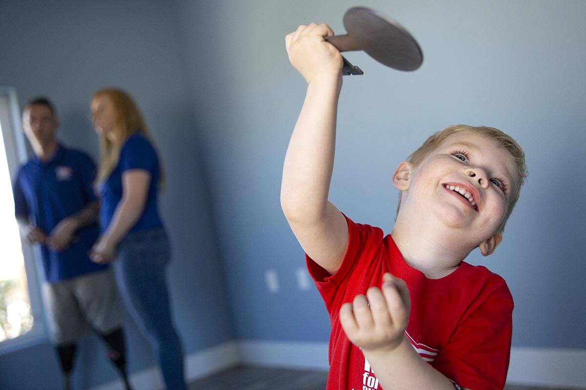 Senna Poppenhouse, 3, plays with the symbolic key to his new home while his parents are intervi ...