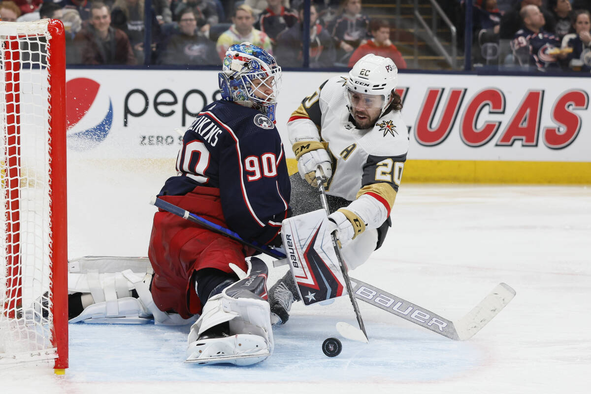 Columbus Blue Jackets' Elvis Merzlikins, left, makes a save against Vegas Golden Knights' Chand ...