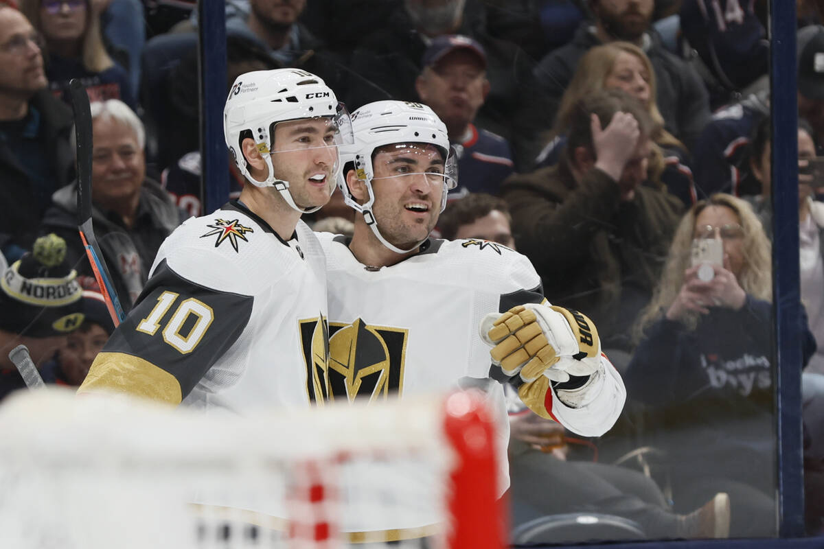 Vegas Golden Knights' Nicolas Roy, left, William Carrier celebrate their goal against the Colum ...