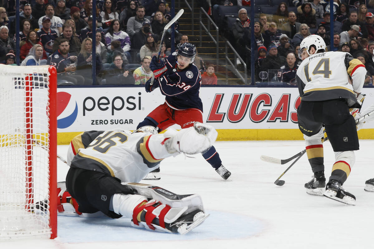 Columbus Blue Jackets' Cole Sillinger, center, scores a hat trick against Vegas Golden Knights' ...