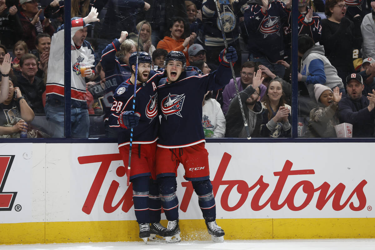 Columbus Blue Jackets' Cole Sillinger, right, celebrates his hat trick against the Vegas Golden ...