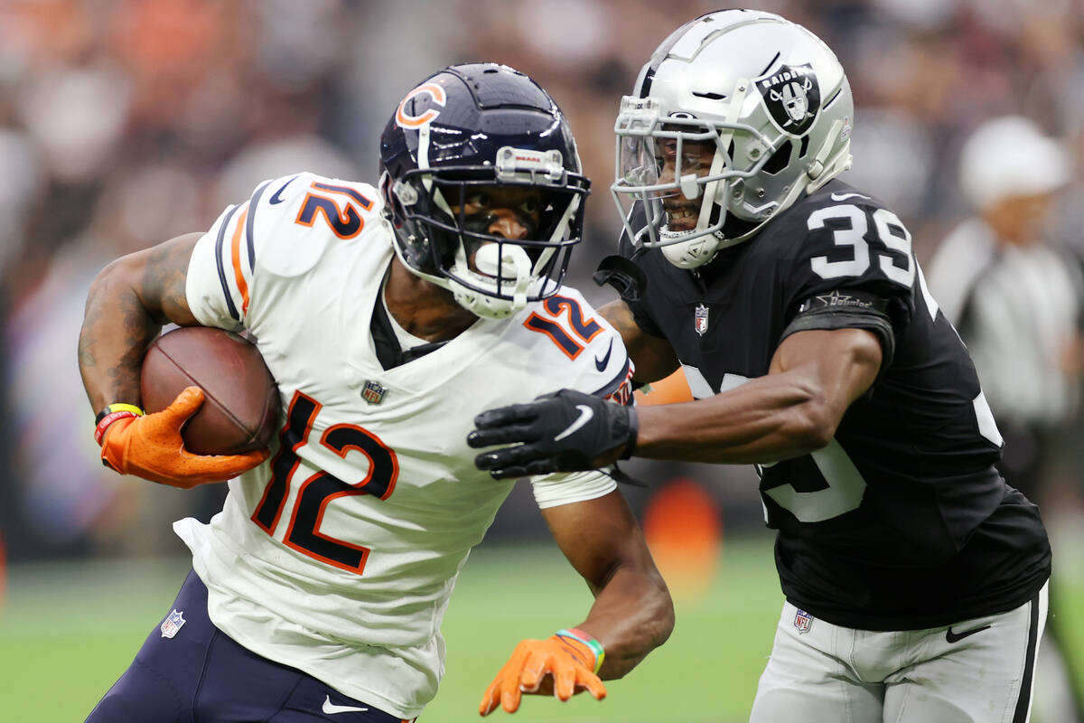 Chicago Bears wide receiver Allen Robinson (12) runs the ball under pressure from Raiders corne ...