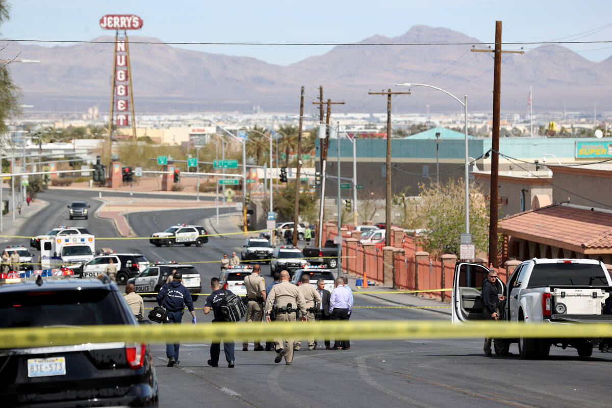 Paramedics arrive as Las Vegas police investigate an officer-involved shooting on North Main St ...