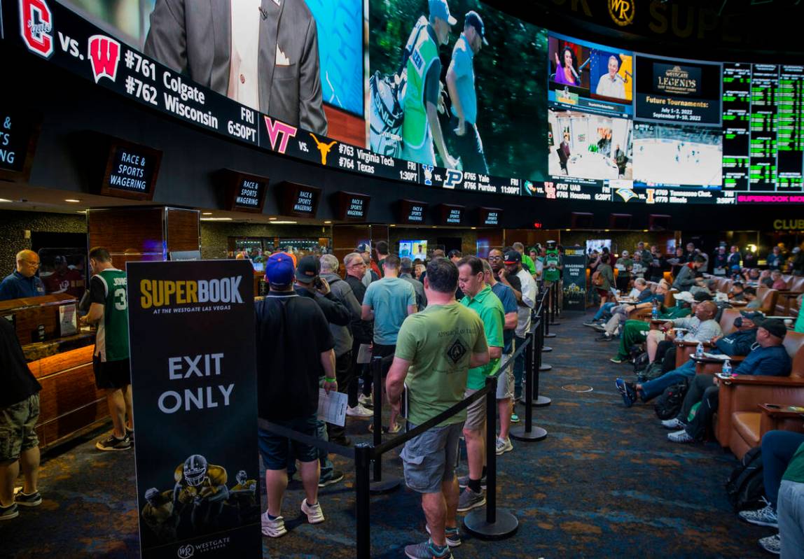 Bettors stand in line to put their money down as March Madness begins in the Superbook at Westg ...