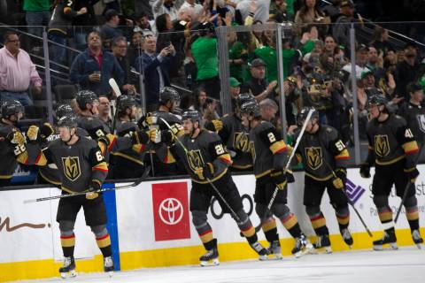 Golden Knights right wing Evgenii Dadonov (63) is congratulated by his team after scoring a goa ...