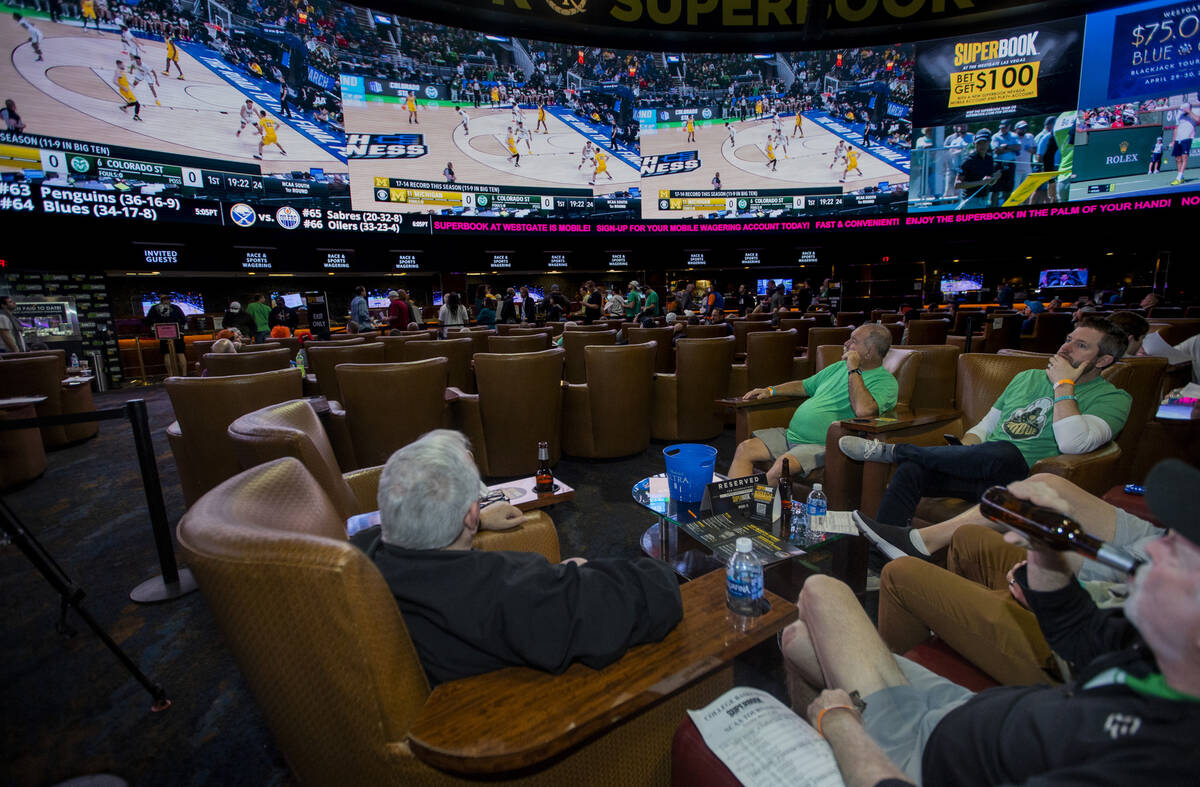 Fans look to the big screens as March Madness begins in the Superbook at Westgate on Thursday, ...