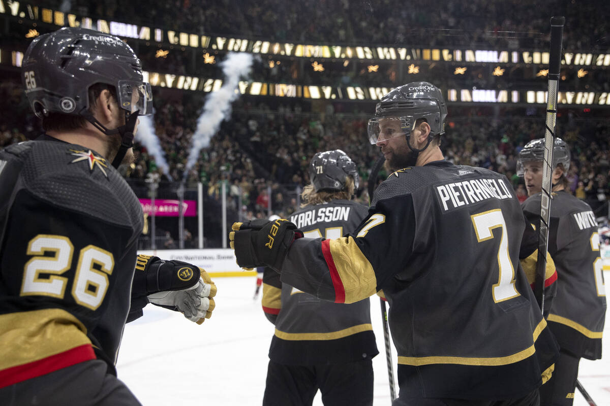 Golden Knights center Mattias Janmark (26) and defenseman Alex Pietrangelo (7) celebrate after ...