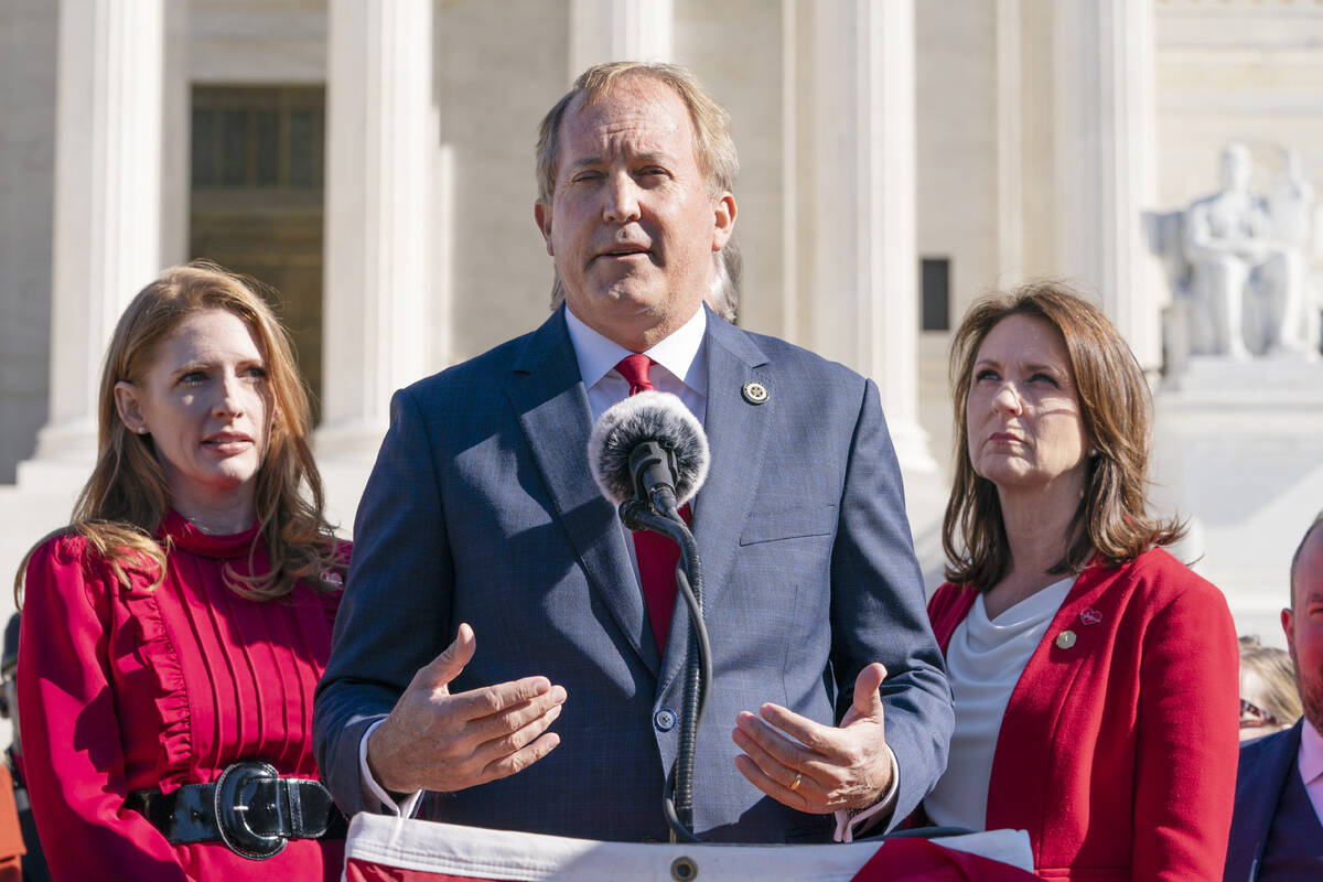 Texas State Rep. Shelby Slawson, left, and Texas State Sen. Angela Paxton, right, listen as Tex ...