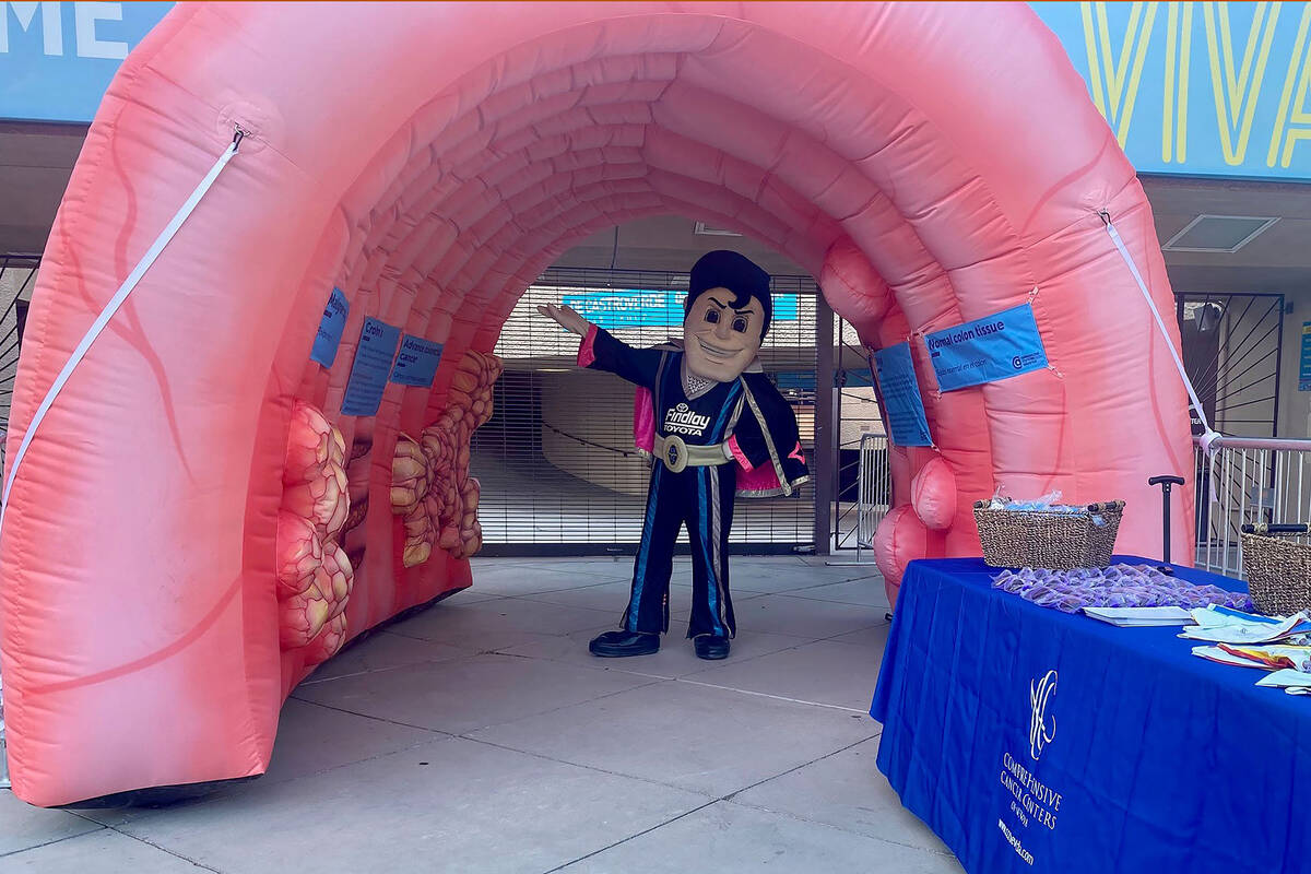 Lights FC mascot Cash the Soccer Rocker walks through an inflatable colon that will greet socce ...