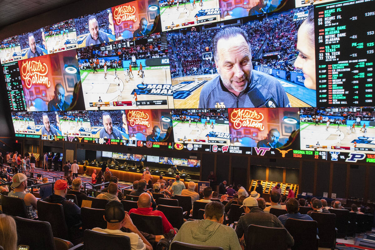 Fans watch basketball games being played on the second day of March Madness from the Circa Spor ...