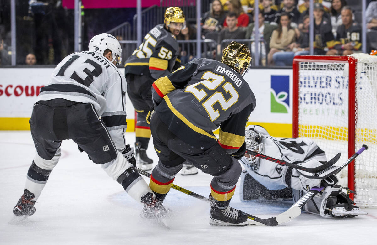 Golden Knights center Michael Amadio (22) slides the puck beneath Los Angeles Kings goaltender ...