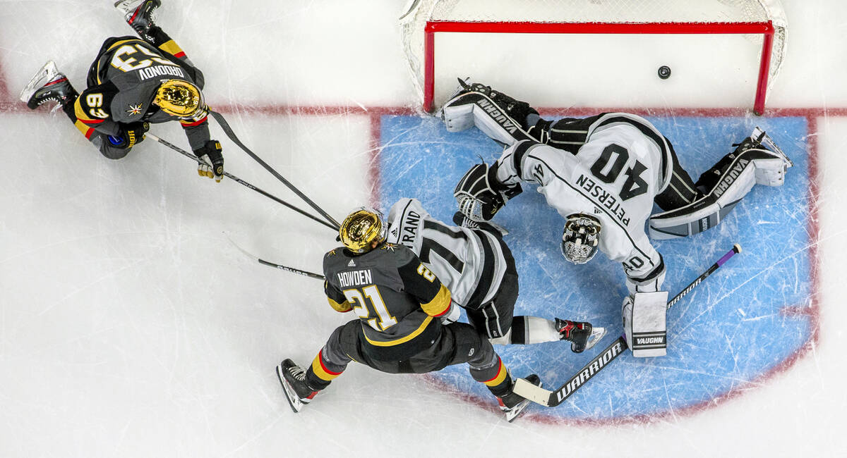 Golden Knights right wing Evgenii Dadonov (63) scores on Los Angeles Kings goaltender Cal Peter ...