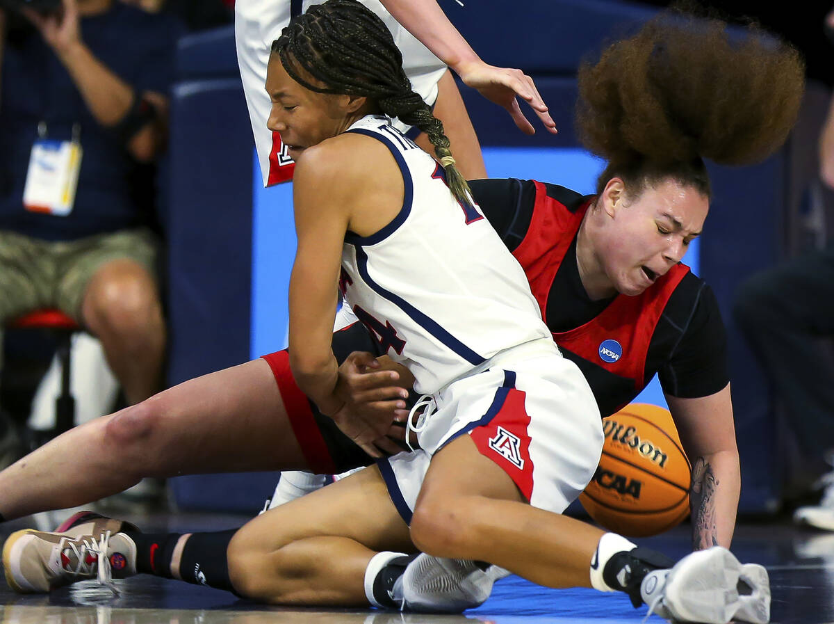 Arizona forward Sam Thomas (14) and UNLV forward Khayla Rooks (20) fall to the court after Thom ...