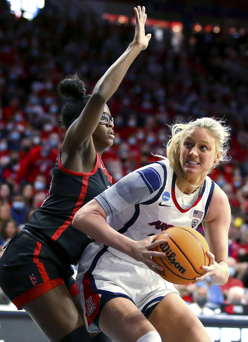 Arizona forward Cate Reese (25) moves around UNLV center Desi-Rae Young (23) while looking for ...