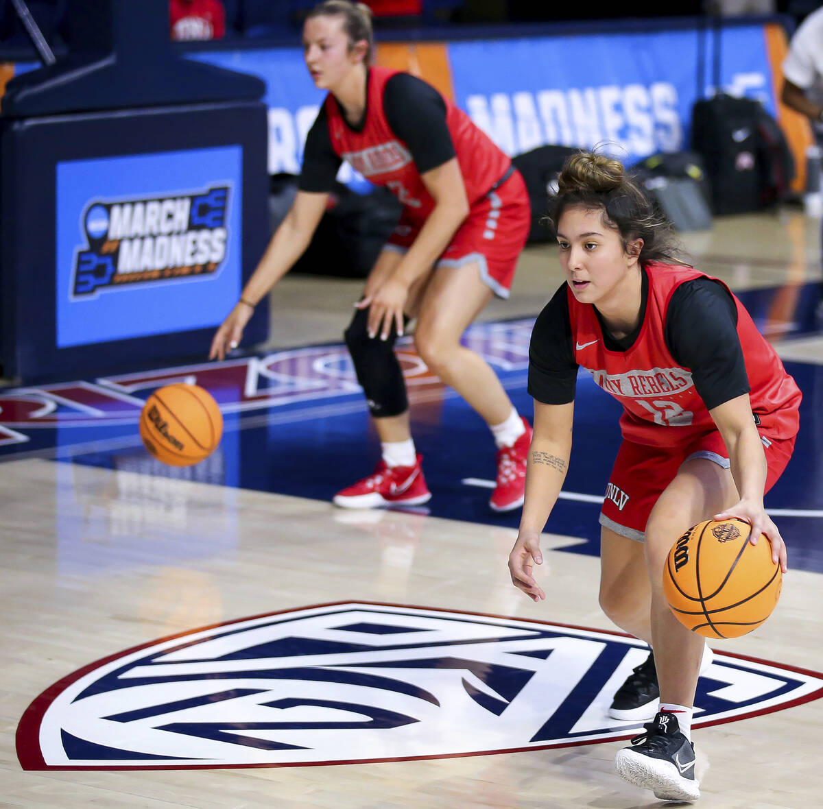 UNLV guard Alyssa Durazo-Frescas (12) and guard Kenadee Winfrey (2) dribble while running throu ...