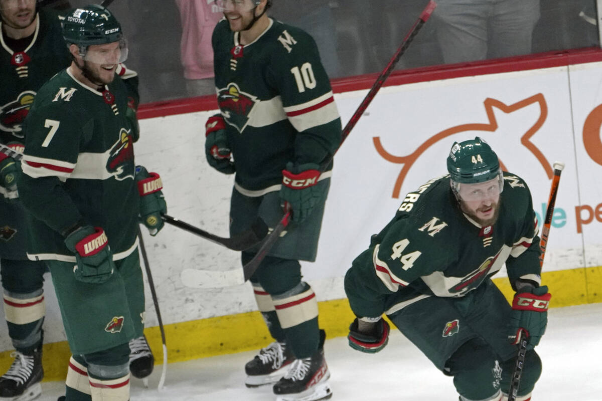 Minnesota Wild's Nicolas Deslauriers, right, skates out of the celebration circle after scoring ...