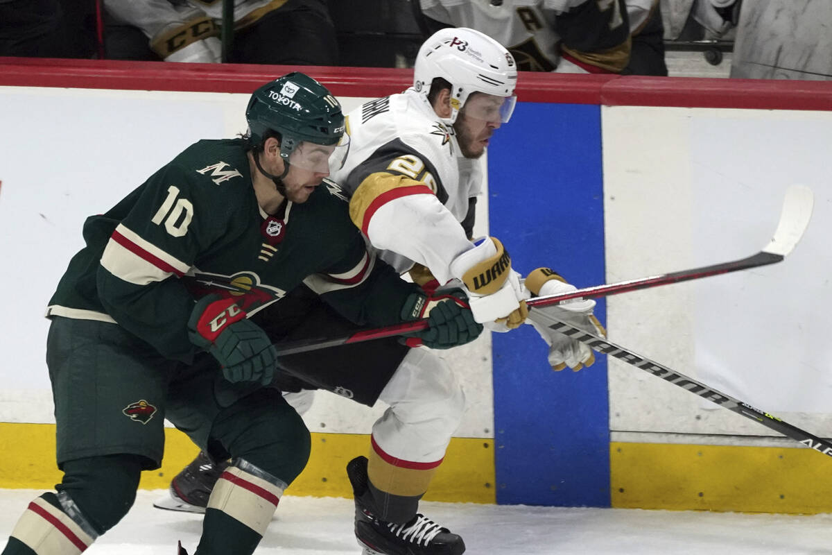 Minnesota Wild's Tyson Jost (10) becomes entangled with Vegas Golden Knights' Mattias Janmark ( ...