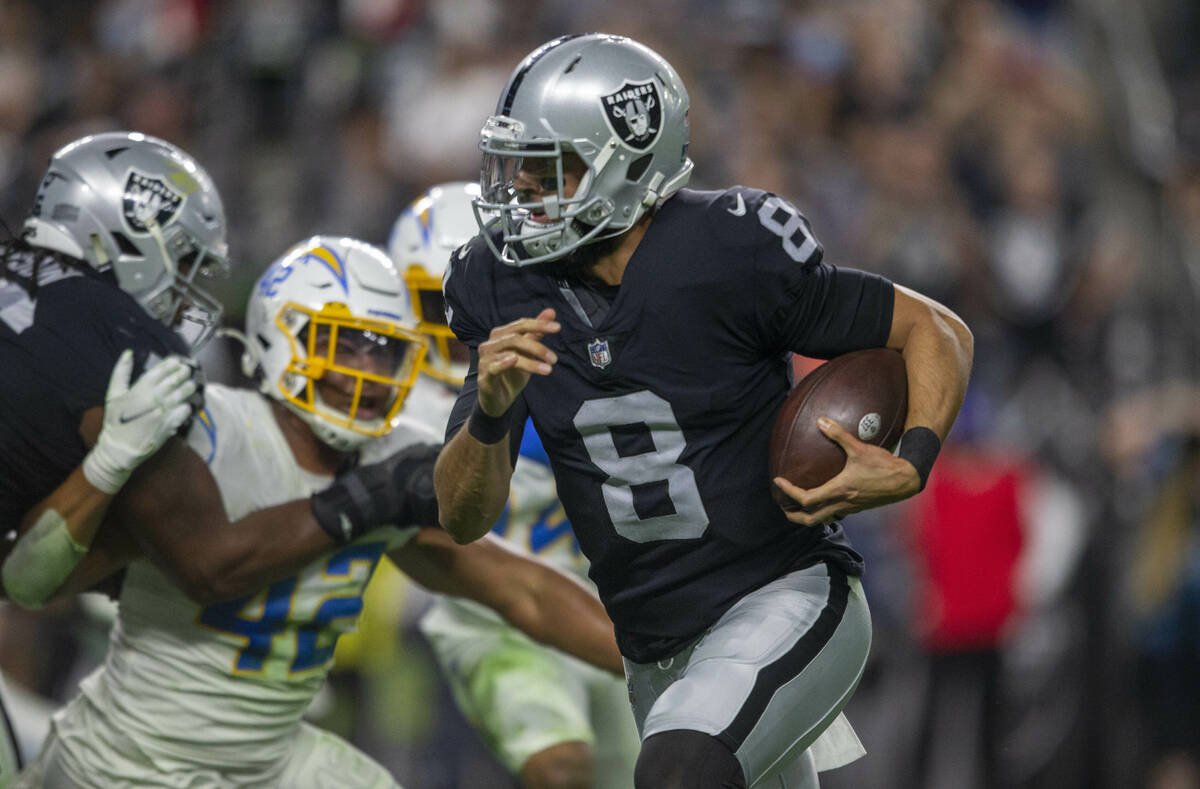 Raiders quarterback Marcus Mariota (8) carries the football against the Los Angeles Chargers du ...