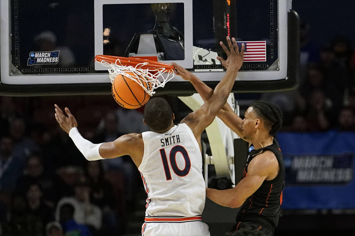 Miami's Isaiah Wong (2) shoots and scores against Auburn forward Jabari Smith (10) during the f ...