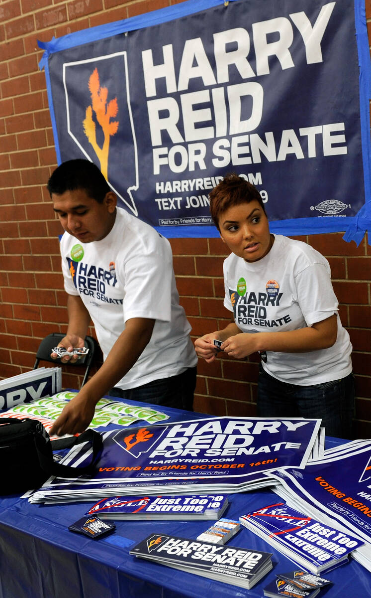 In this October 12, 2010, file photo, Harry Reid campaign interns Javier Rivera, left, and Gabr ...