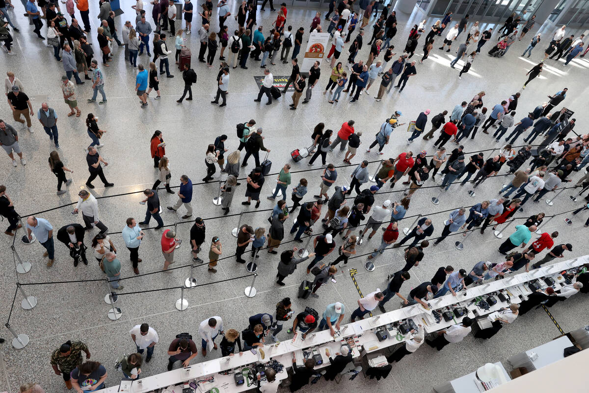 Conventioneers queue to pick up their badges at the International Pizza Expo as part of the fir ...