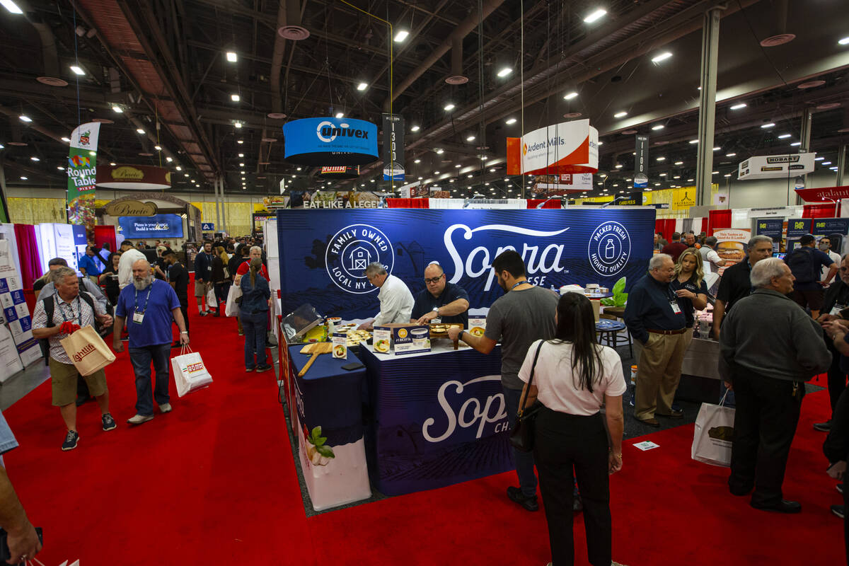 Attendees walk the show floor and try samples during the International Pizza Expo at the Las Ve ...