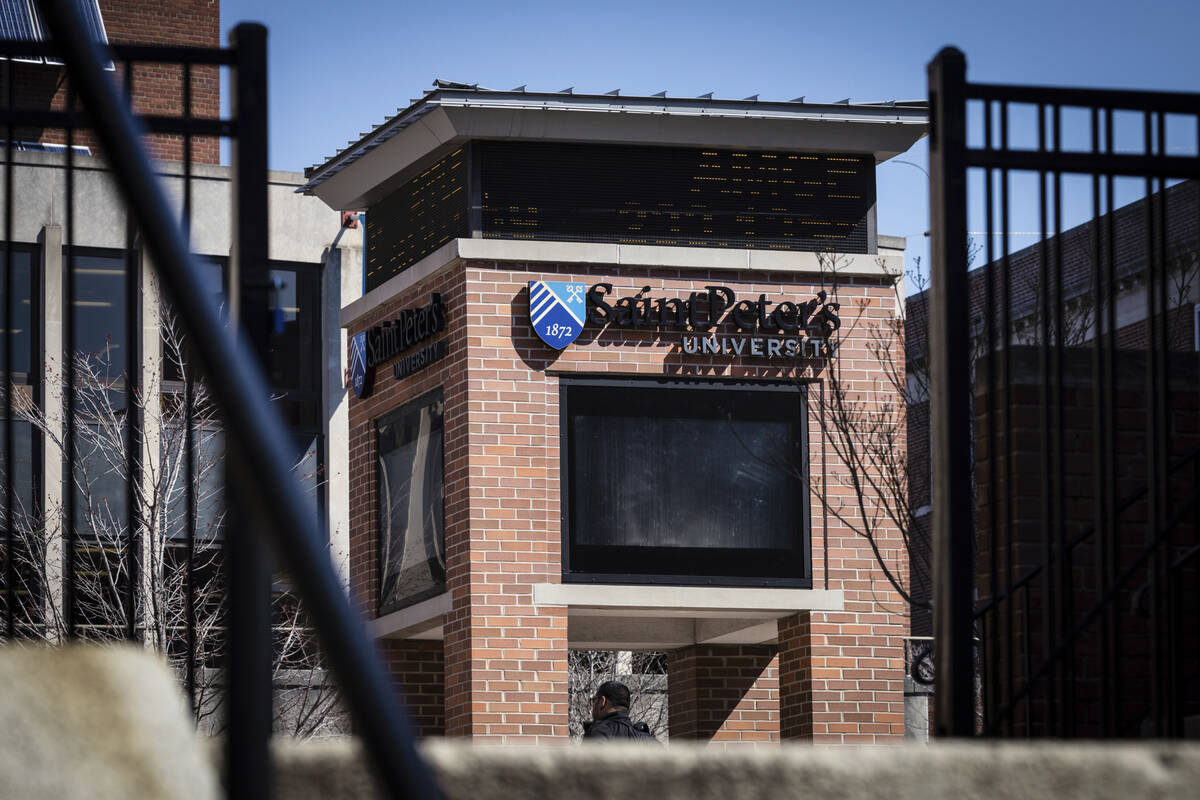 A student walks through the St.Peter's University campus on Friday, March 18, 2022 in Jersey Ci ...