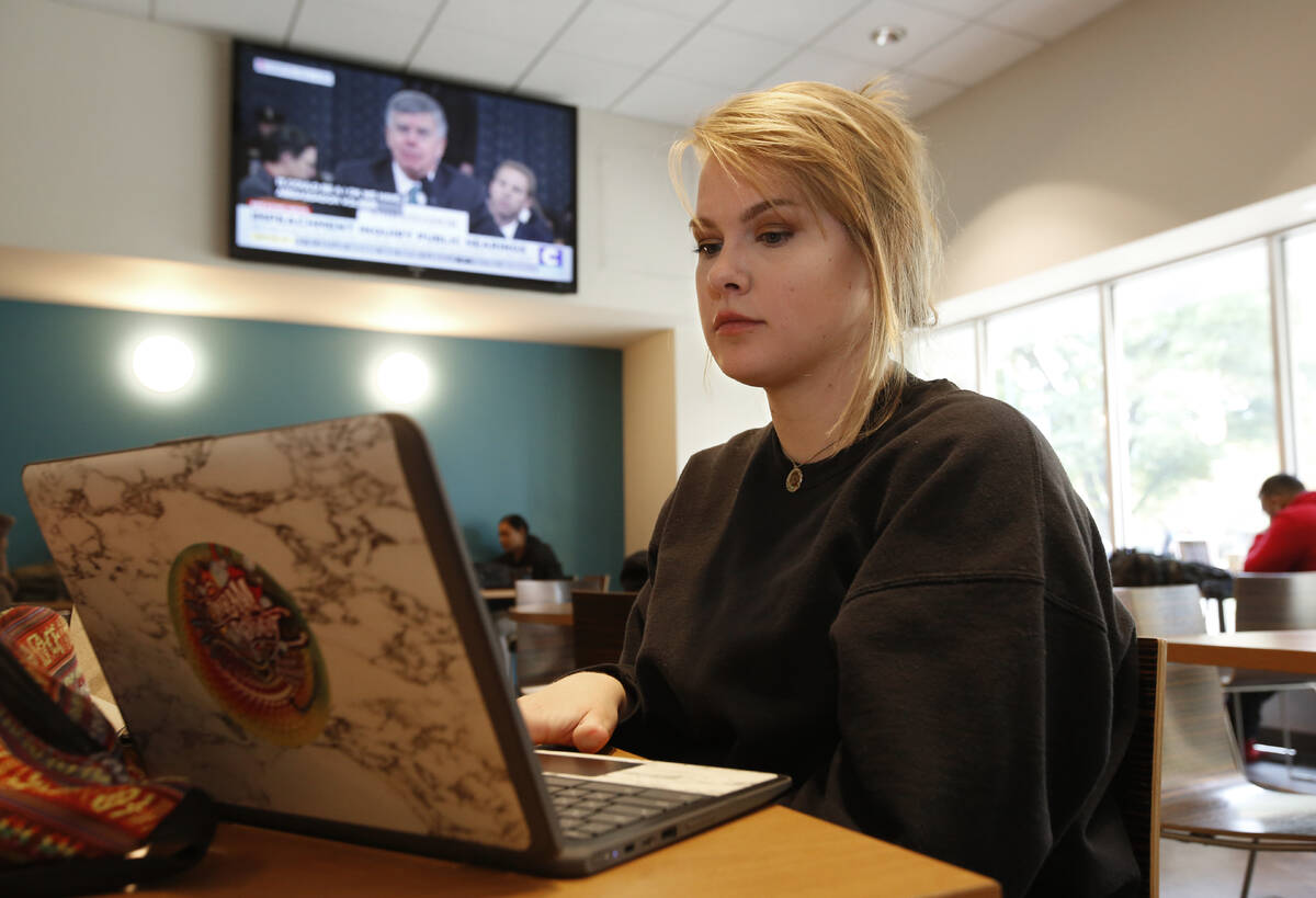 Biology major Catherine Mitchell works on her laptop during a break between classes, at Califor ...