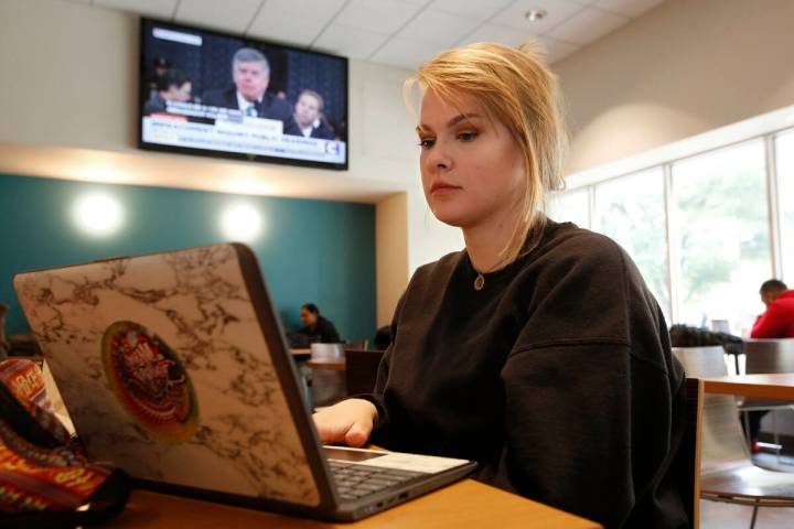 Biology major Catherine Mitchell works on her laptop during a break between classes, at Califor ...