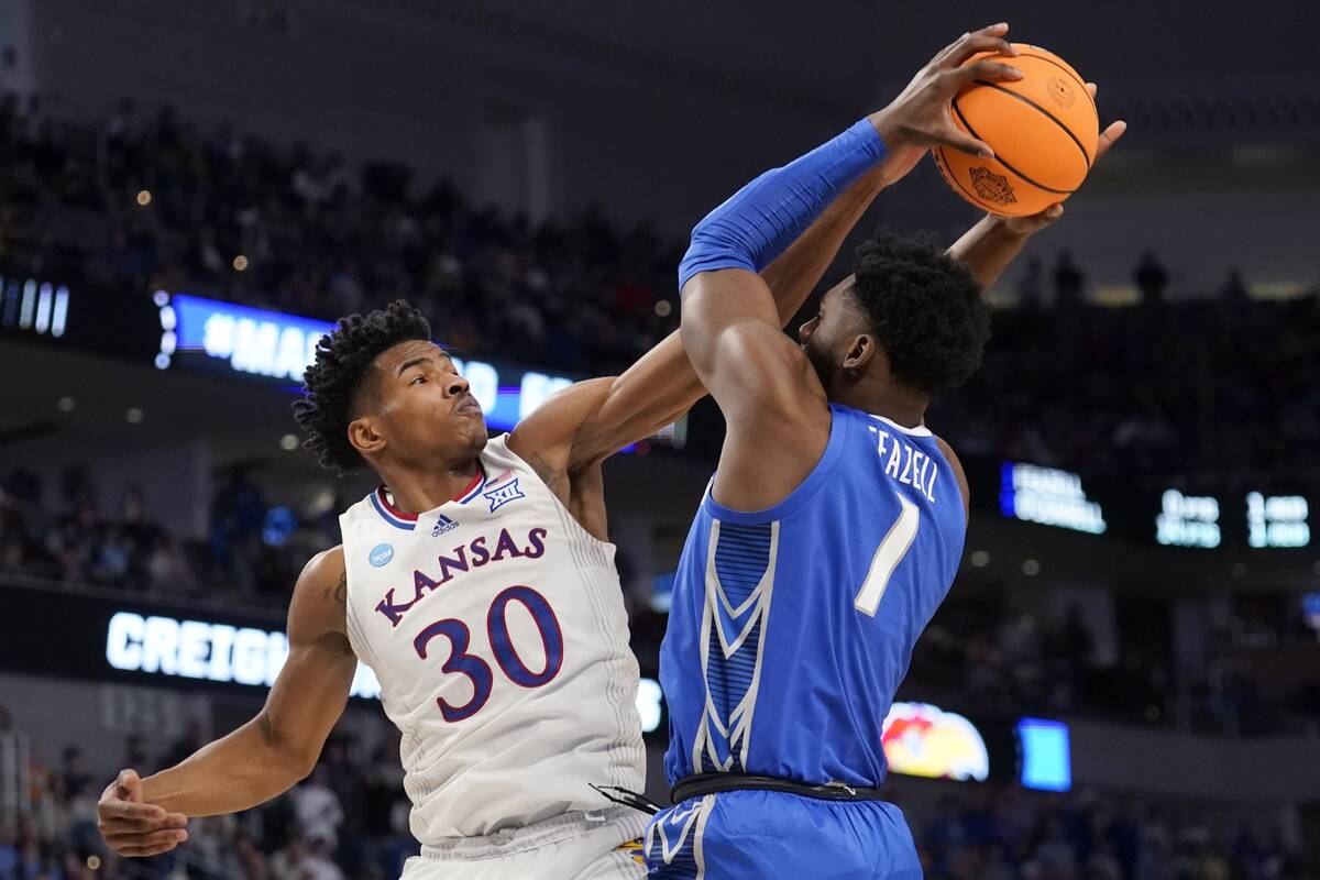 Kansas guard Ochai Agbaji (30) blocks a shot attempt by Creighton forward KeyShawn Feazell (1) ...