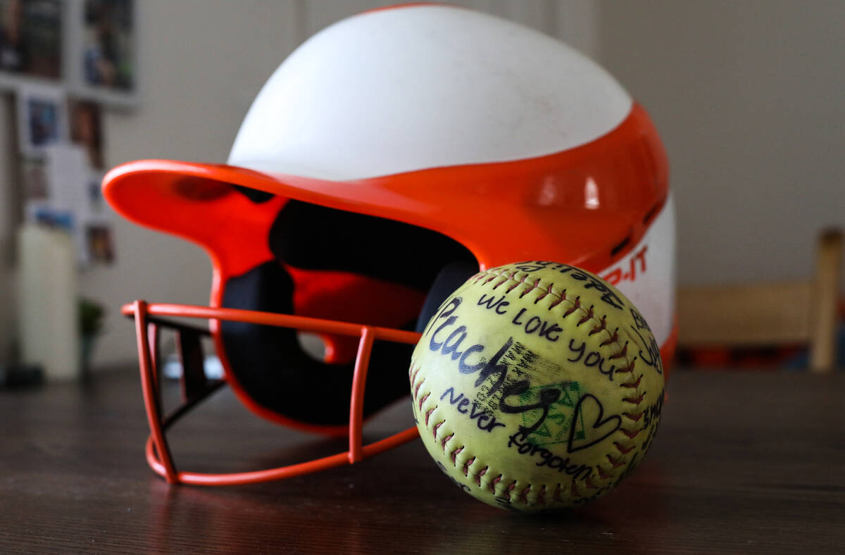 Georgia Durmeier’s softball helmet and softball signed by players from her team, with her nic ...