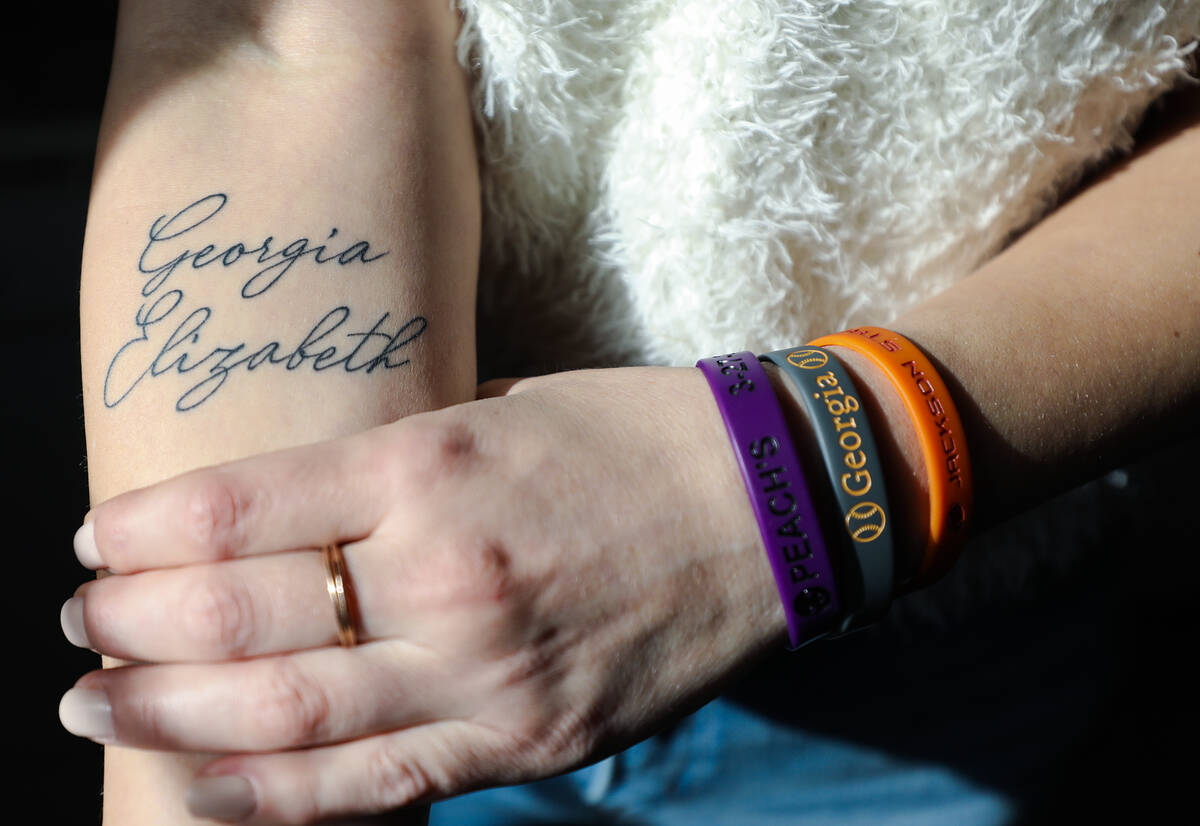 Chelsea Roberts shows a tattoo and bracelets with her daughter Georgia Durmeier’s name at her ...