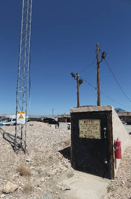 A radio tower stands next to the entrance to a bunker that sits locked and largely forgotten un ...