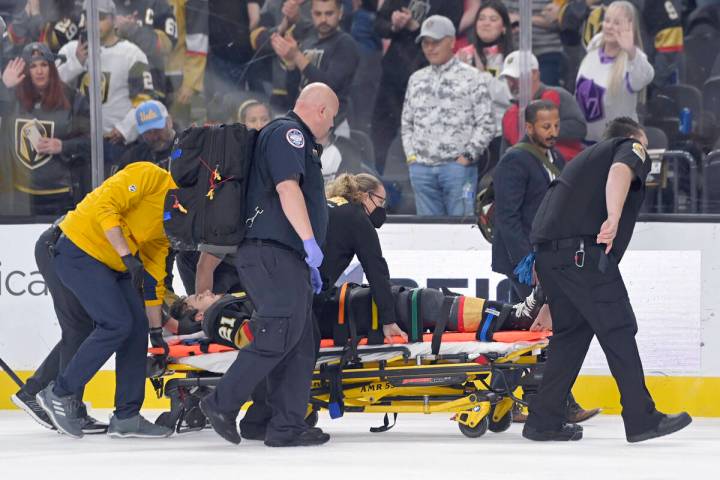 Vegas Golden Knights center Brett Howden is carried off the ice after an injury during the firs ...